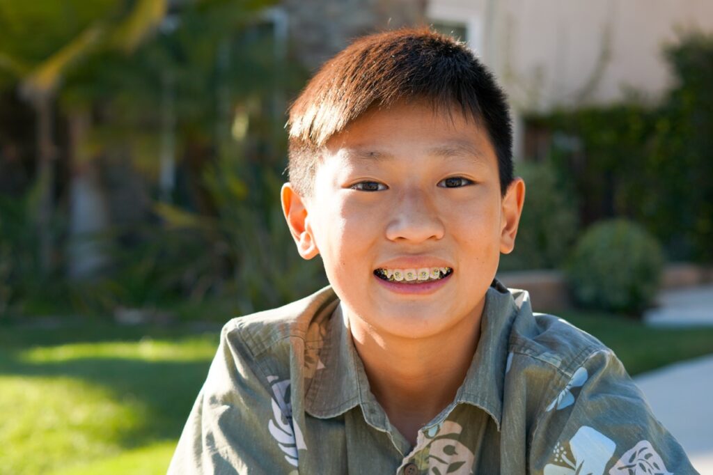 young boy smiling with braces