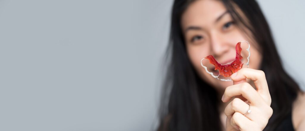 woman holding a retainer